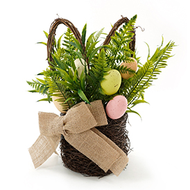 Easter eggs and faux fern leaves in bunny basket arrangement