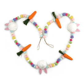 Spring garland with colorful pom poms and carrot